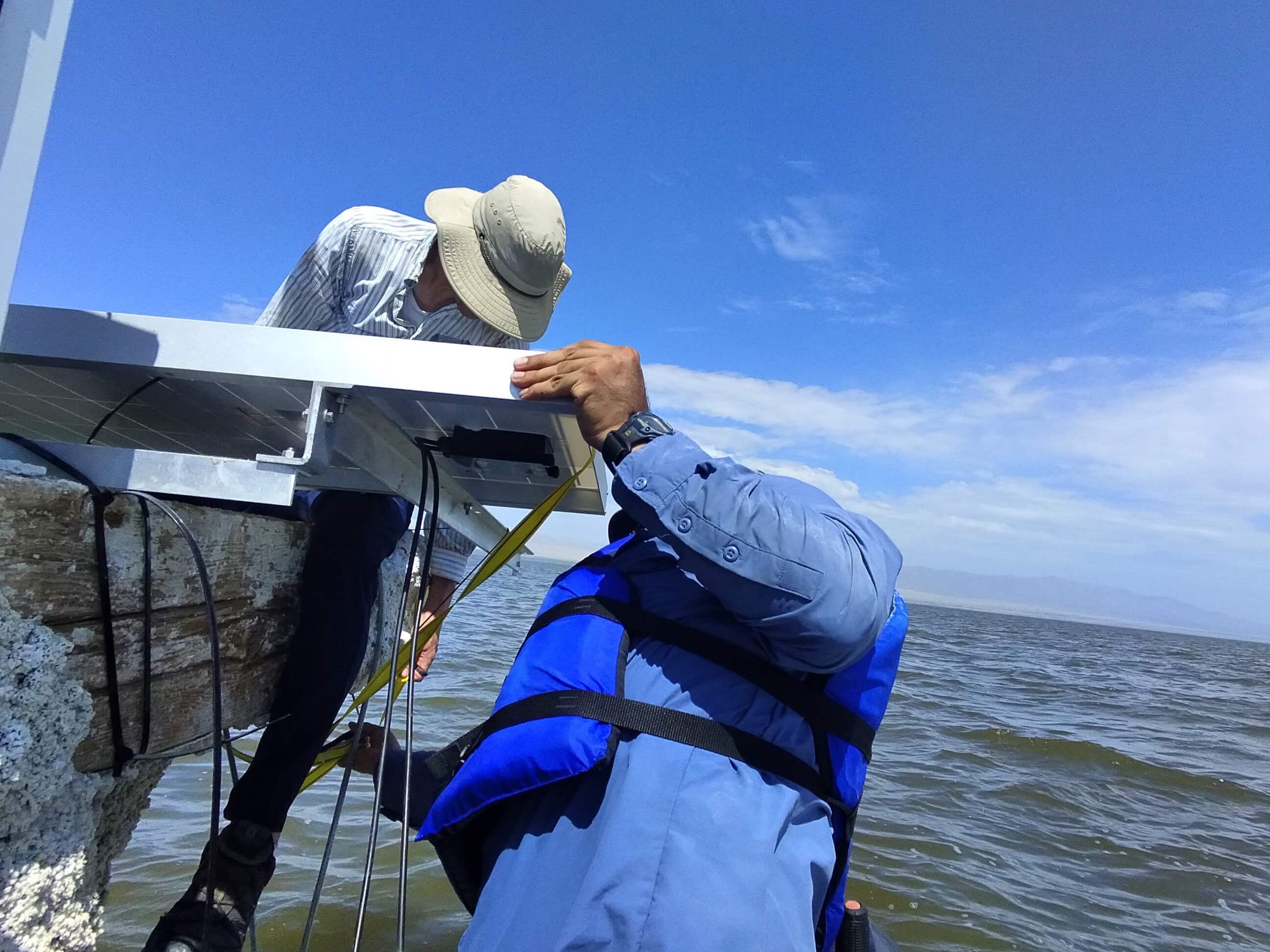 two men installing aeroqual sensor